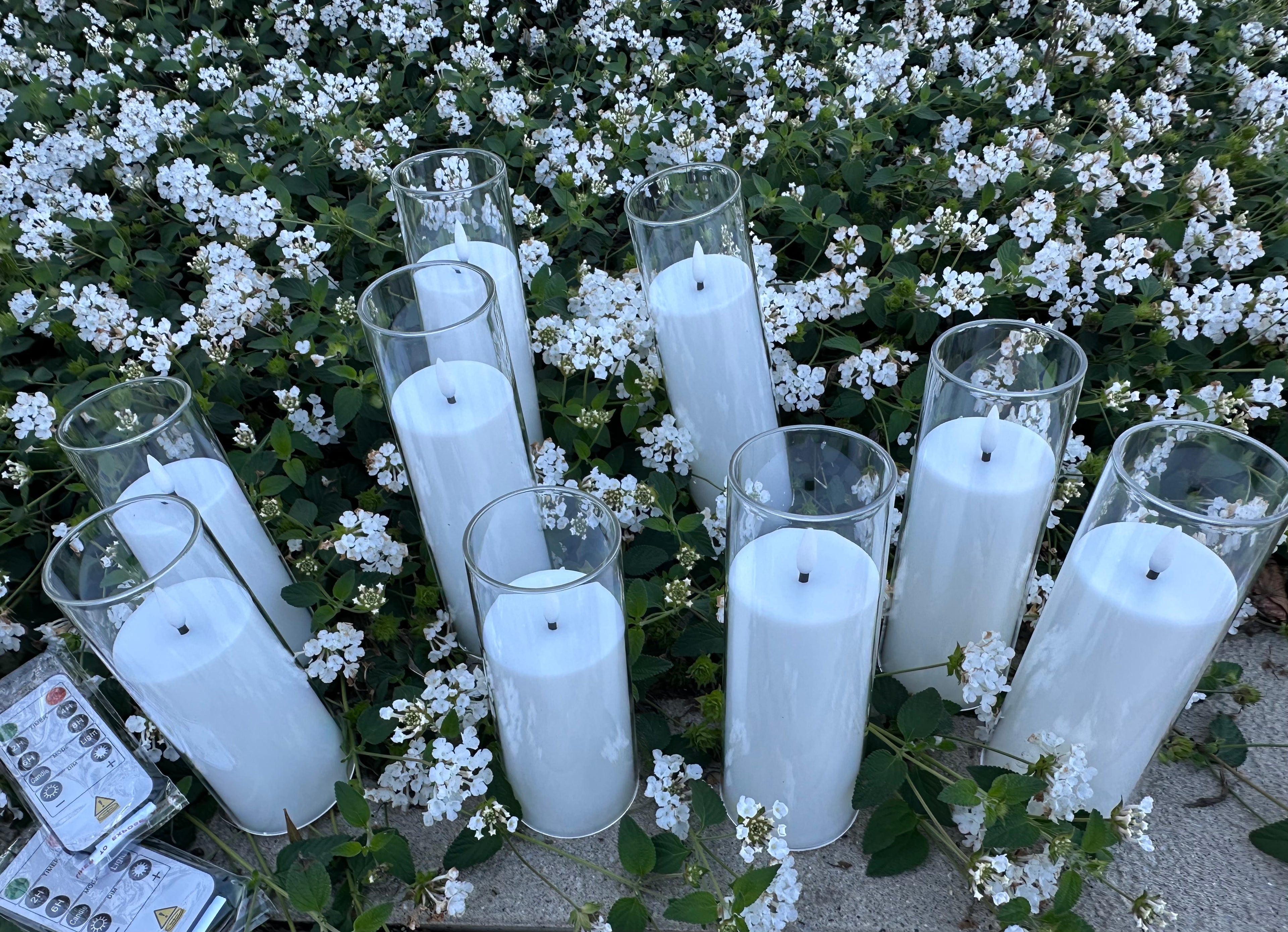 9 - White Flameless Battery-operated candles that last over 300 hours on just one single battery! Requires - AA battery (not included) Comes with 2 remote. Pack of 9 candles. $40