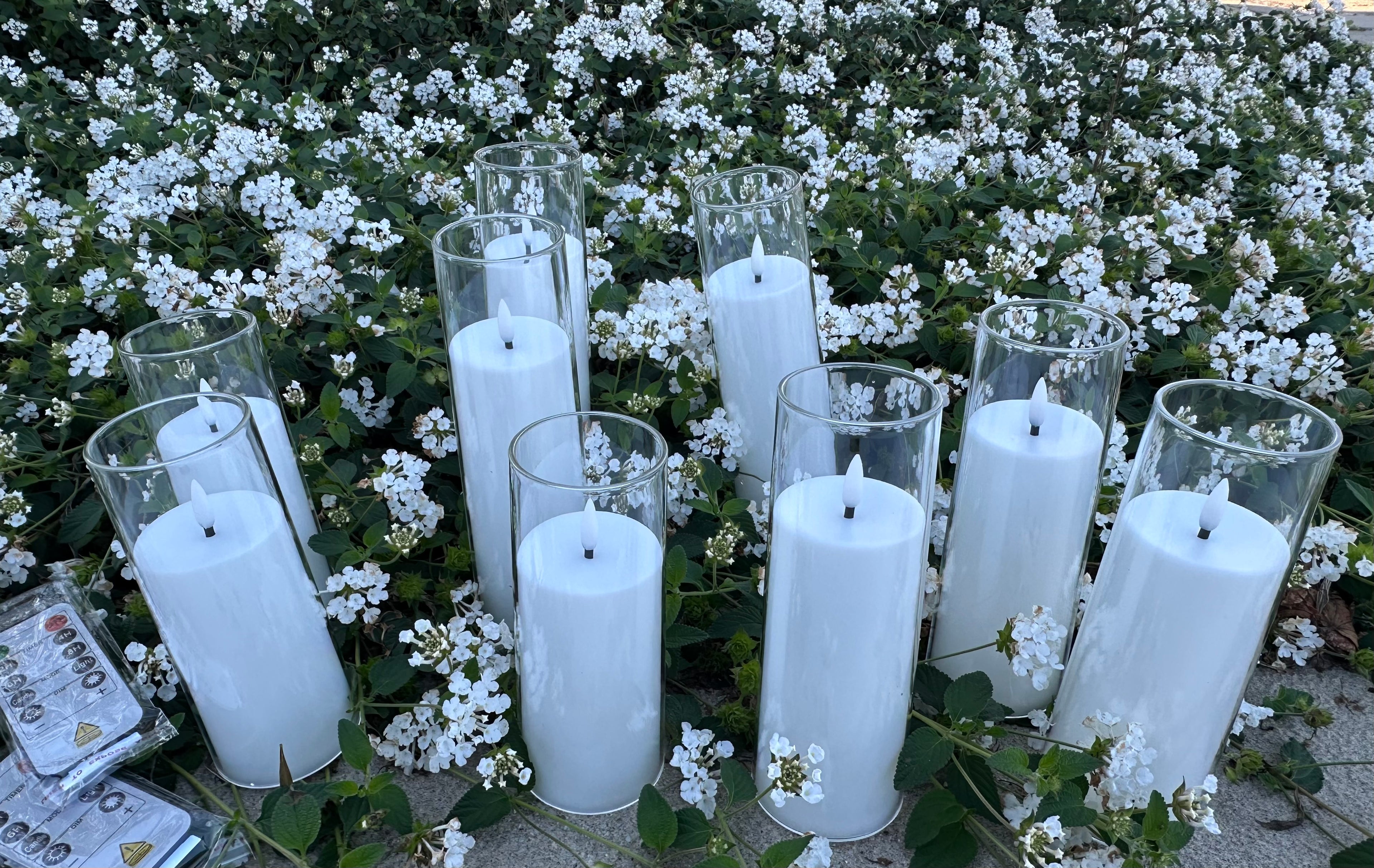 9 - White Flameless Battery-operated candles that last over 300 hours on just one single battery! Requires - AA battery (not included) Comes with 2 remote. Pack of 9 candles. $40